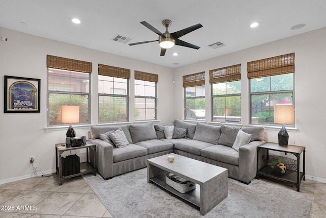 living room with ceiling fan and light tile patterned flooring