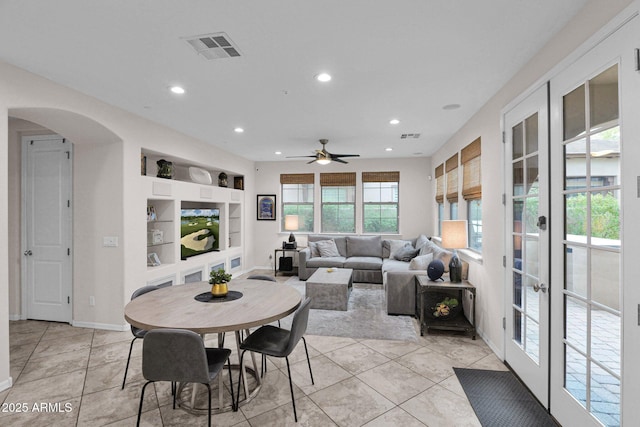 dining space with built in shelves, ceiling fan, light tile patterned flooring, and french doors