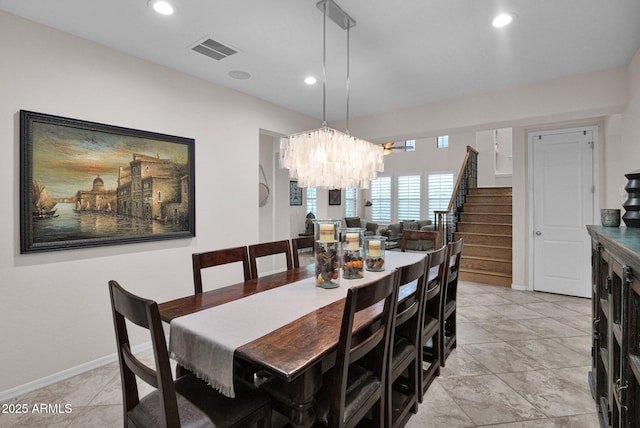 tiled dining room with a notable chandelier