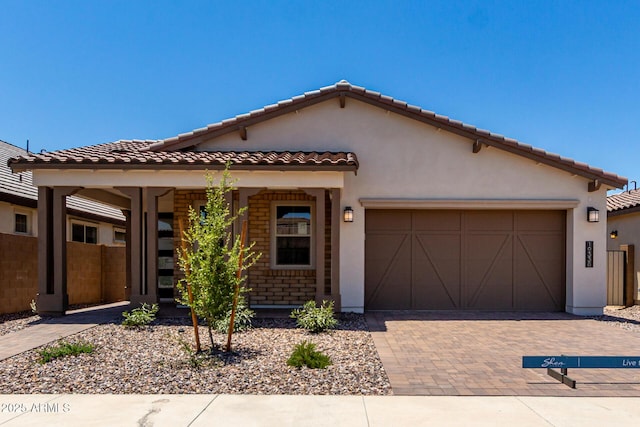 19338 S 212th Pl, Queen Creek, AZ 85142 - mediterranean / spanish-style house featuring a garage, a tiled roof, stucco siding, and decorative driveway