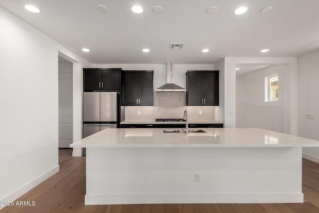 19338 S 212th Pl, Queen Creek, AZ 85142 - kitchen featuring wall chimney exhaust hood, freestanding refrigerator, light wood finished floors, decorative backsplash, and recessed lighting