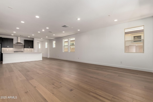 19338 S 212th Pl, Queen Creek, AZ 85142 - unfurnished living room with light wood-type flooring and recessed lighting