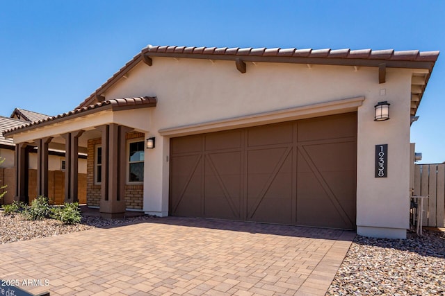 19338 S 212th Pl, Queen Creek, AZ 85142 - mediterranean / spanish-style house featuring an attached garage, decorative driveway, a tile roof, and stucco siding