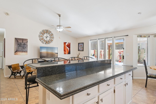 3133 E Redwood Ct, Phoenix, AZ 85048 - kitchen featuring light tile patterned floors, ceiling fan, lofted ceiling, dark countertops, and white cabinetry