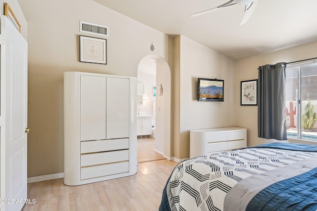 3133 E Redwood Ct, Phoenix, AZ 85048 - bedroom with lofted ceiling, arched walkways, light wood-style flooring, ensuite bathroom, and ceiling fan