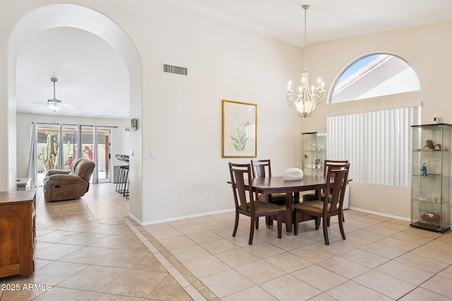 3133 E Redwood Ct, Phoenix, AZ 85048 - dining area featuring arched walkways, plenty of natural light, light tile patterned floors, a towering ceiling, and a chandelier