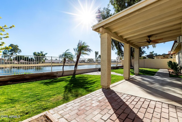 view of patio featuring ceiling fan and a water view