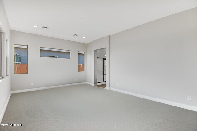 carpeted empty room featuring recessed lighting, visible vents, and baseboards