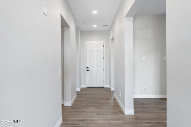 hall with recessed lighting, baseboards, and wood finished floors