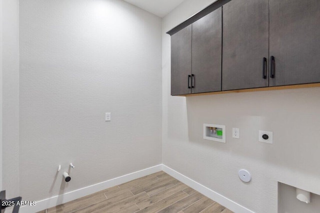 clothes washing area featuring light wood-style floors, hookup for a washing machine, cabinet space, and hookup for a gas dryer