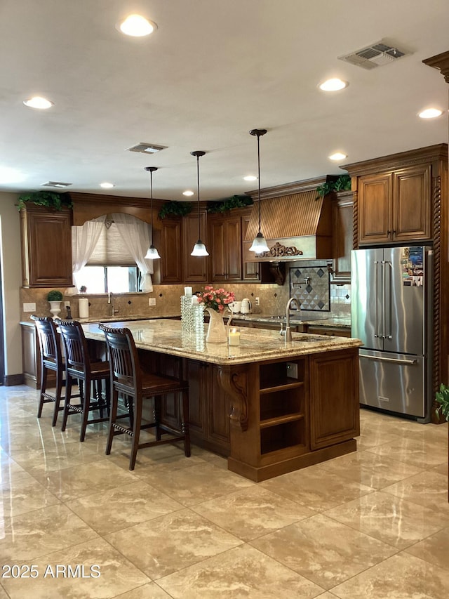 6540 E Wildcat Dr, Cave Creek, AZ 85331 - kitchen featuring high end refrigerator, decorative backsplash, recessed lighting, light stone countertops, and a kitchen island with sink