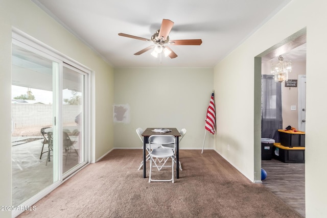 misc room with carpet floors and ceiling fan with notable chandelier