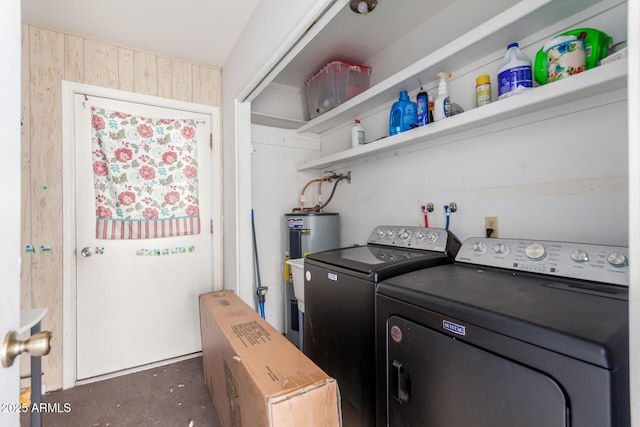 laundry area with water heater and washing machine and clothes dryer