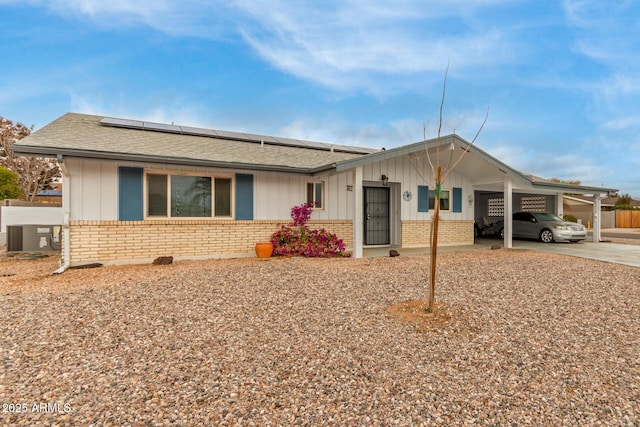 single story home with central AC unit and a carport