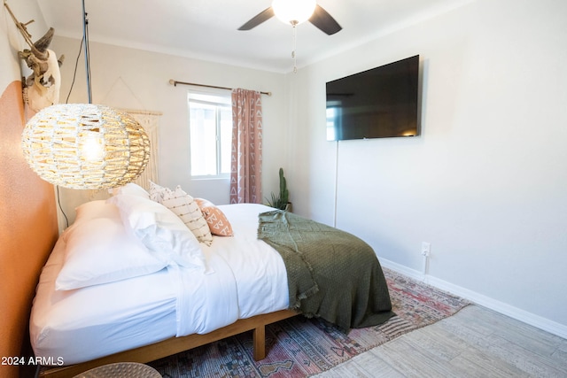 bedroom with ceiling fan and hardwood / wood-style flooring