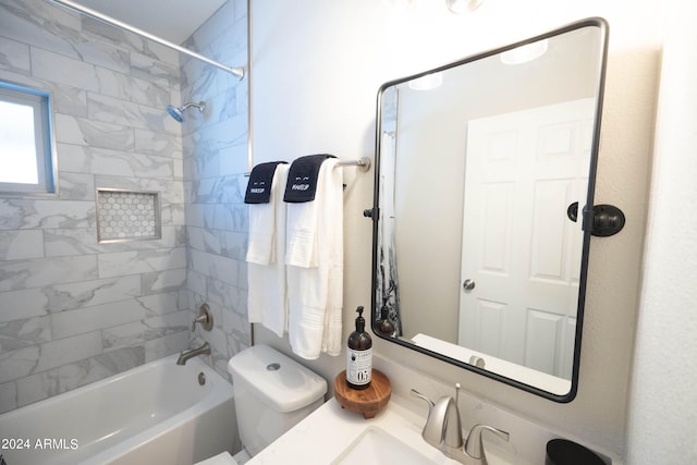 full bathroom featuring toilet, tiled shower / bath combo, and vanity