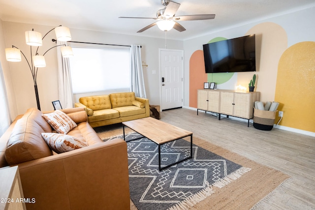 living room featuring ceiling fan and light wood-type flooring