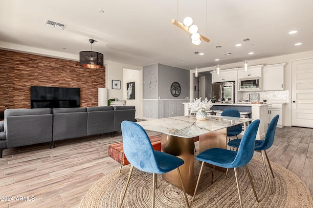 dining space with light hardwood / wood-style floors