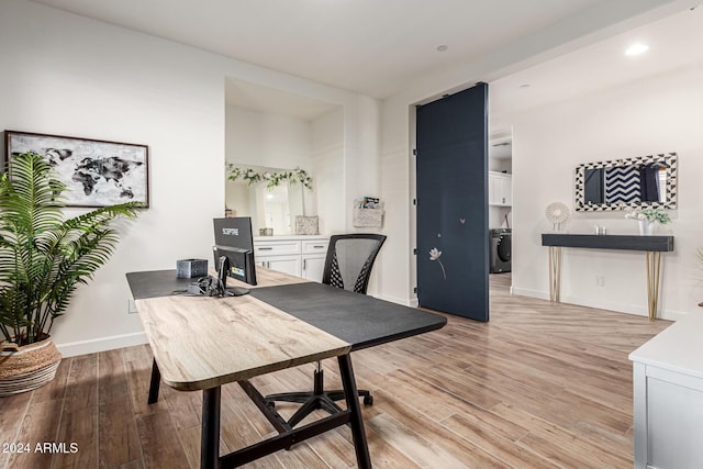 office space featuring washer / dryer and light wood-type flooring