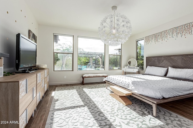 bedroom featuring dark wood-type flooring and an inviting chandelier