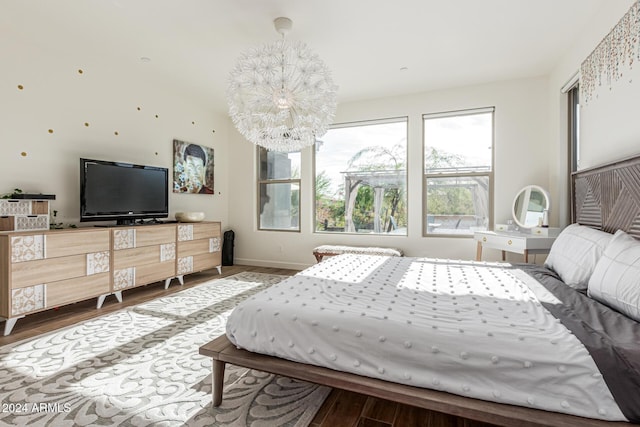 bedroom with a chandelier and hardwood / wood-style floors