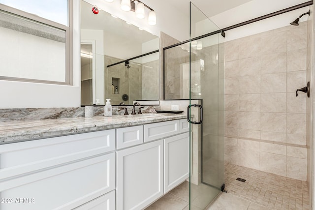 bathroom featuring tile patterned flooring, vanity, and an enclosed shower