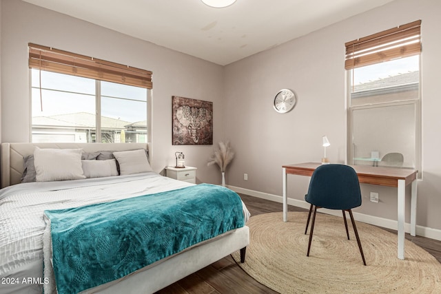 bedroom with hardwood / wood-style floors and multiple windows