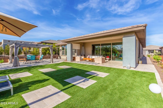 back of property featuring a pergola, a yard, and a patio