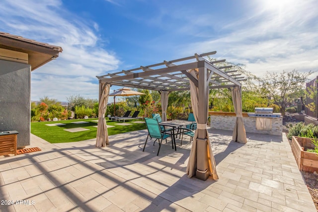 view of patio with an outdoor kitchen and a pergola