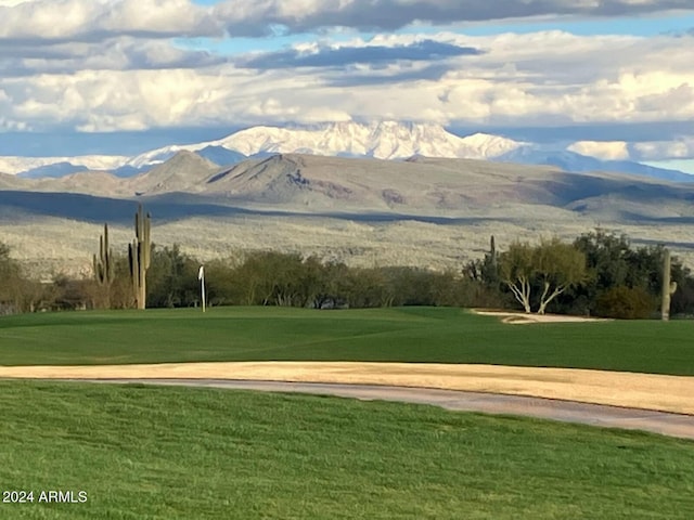 view of home's community featuring a lawn and a mountain view