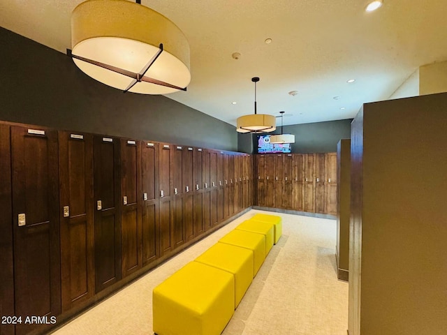 corridor featuring light colored carpet and vaulted ceiling