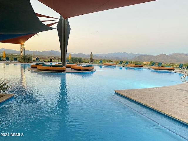 pool at dusk with a mountain view