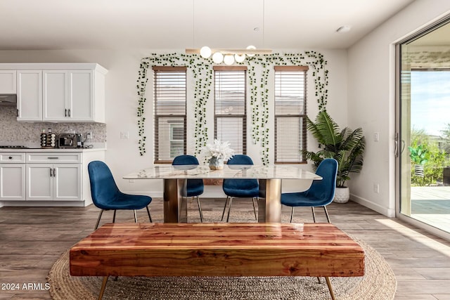 dining space featuring plenty of natural light and light hardwood / wood-style flooring