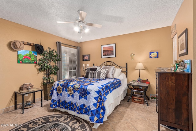 bedroom with ceiling fan, a textured ceiling, and light tile patterned floors