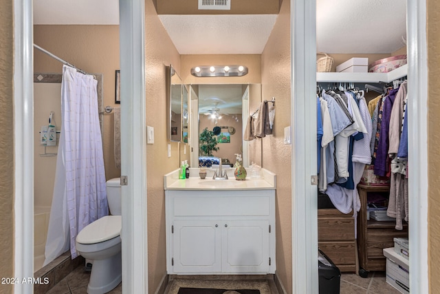 bathroom featuring toilet, a shower with curtain, vanity, and tile patterned flooring