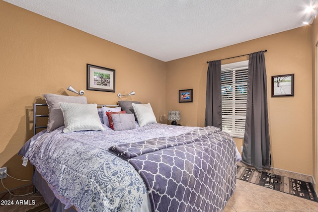 tiled bedroom with a textured ceiling