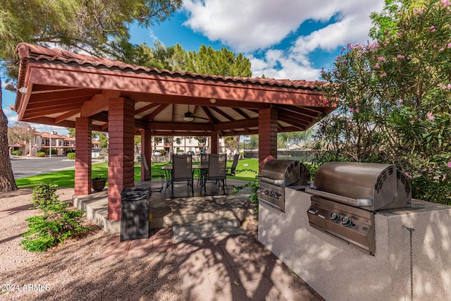 view of patio featuring ceiling fan, area for grilling, and a gazebo