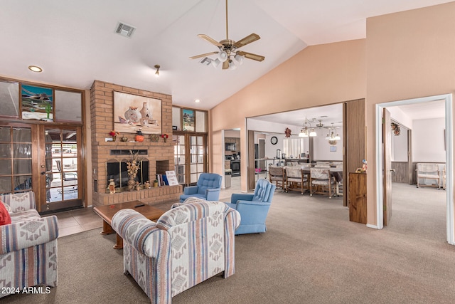 living room with carpet flooring, a brick fireplace, ceiling fan, and high vaulted ceiling