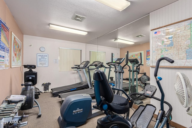 exercise room with a textured ceiling