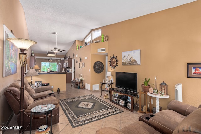 living room with vaulted ceiling, light tile patterned floors, ceiling fan, and plenty of natural light