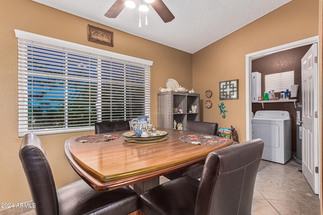 tiled dining room with a textured ceiling, ceiling fan, and washer / dryer