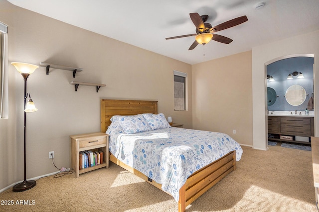 carpeted bedroom featuring ceiling fan, sink, and ensuite bathroom