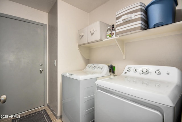 laundry area with independent washer and dryer and tile patterned flooring