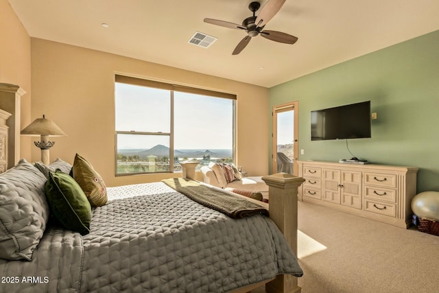 bedroom featuring light colored carpet and ceiling fan