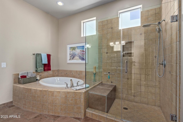 bathroom with shower with separate bathtub and tile patterned floors