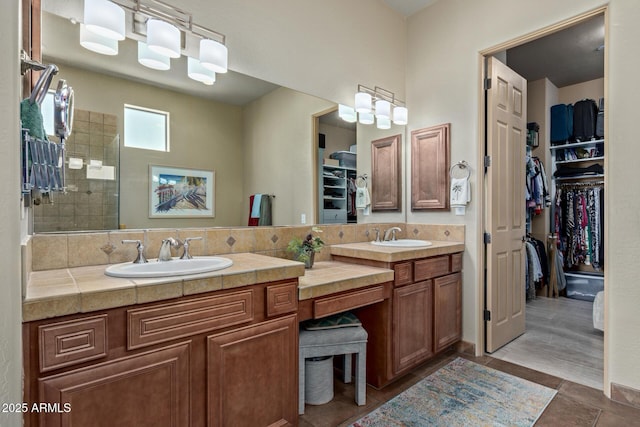 bathroom with vanity, decorative backsplash, and walk in shower