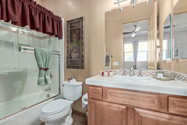 full bathroom with vanity, ceiling fan, shower / bath combination with glass door, and toilet