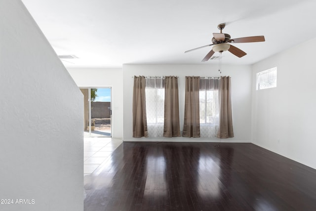 empty room with ceiling fan and hardwood / wood-style flooring