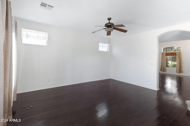 empty room featuring ceiling fan and dark hardwood / wood-style floors