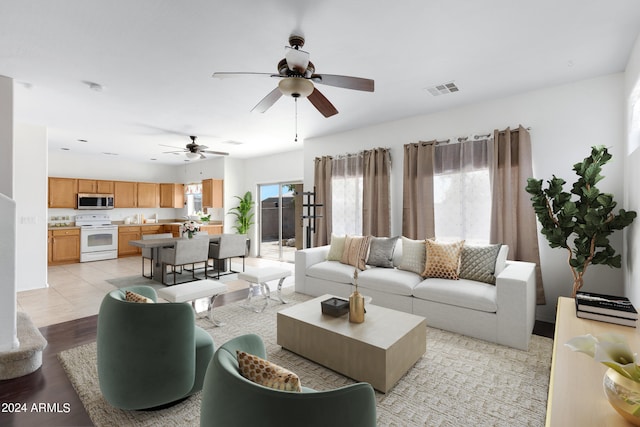 living room featuring light hardwood / wood-style flooring and ceiling fan